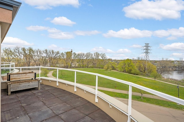 view of patio / terrace with a balcony and a water view