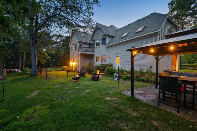 39050 Twin Lakes Rd, Menahga, MN 56464 - view of yard featuring an outdoor fire pit, a patio area, a gazebo, and fence
