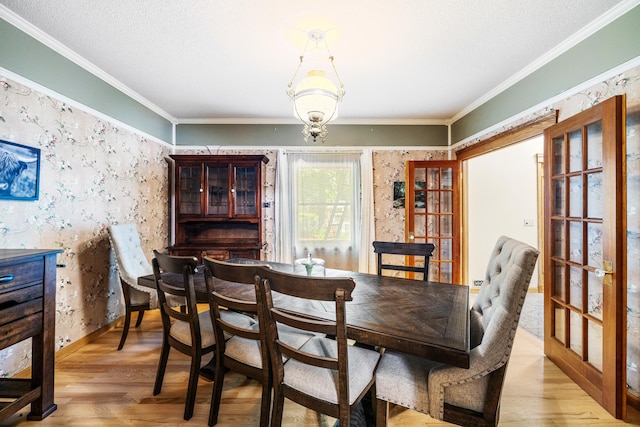 dining area featuring crown molding and hardwood / wood-style floors