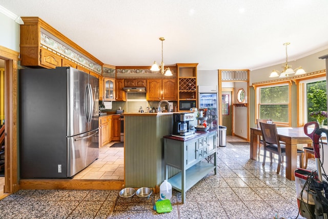 kitchen featuring stainless steel refrigerator, a chandelier, light tile patterned floors, pendant lighting, and ornamental molding