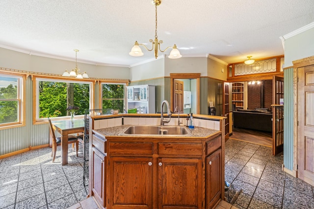 39050 Twin Lakes Rd, Menahga, MN 56464 - kitchen with a textured ceiling, a chandelier, ornamental molding, and a sink