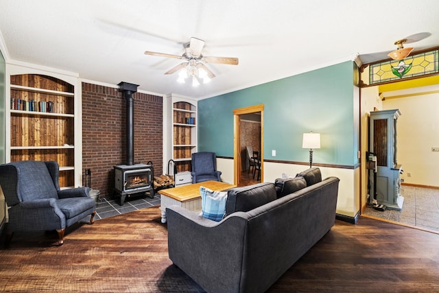 39050 Twin Lakes Rd, Menahga, MN 56464 - living area featuring ornamental molding, a wood stove, ceiling fan, and built in shelves