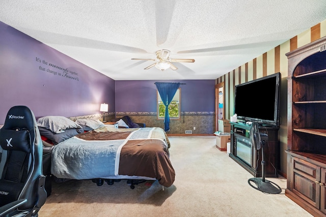 39050 Twin Lakes Rd, Menahga, MN 56464 - bedroom featuring carpet, a ceiling fan, wallpapered walls, a wainscoted wall, and a textured ceiling