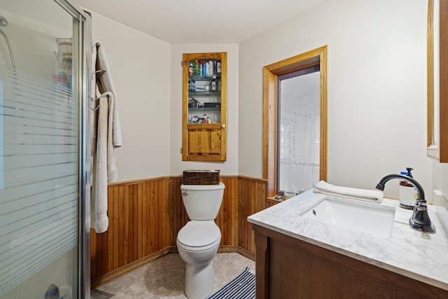 39050 Twin Lakes Rd, Menahga, MN 56464 - bathroom featuring toilet, a wainscoted wall, vanity, wooden walls, and a shower stall