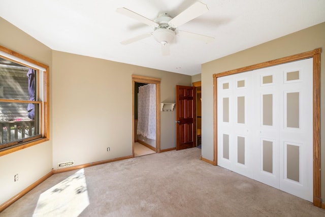 39050 Twin Lakes Rd, Menahga, MN 56464 - unfurnished bedroom with a closet, visible vents, ceiling fan, carpet floors, and baseboards