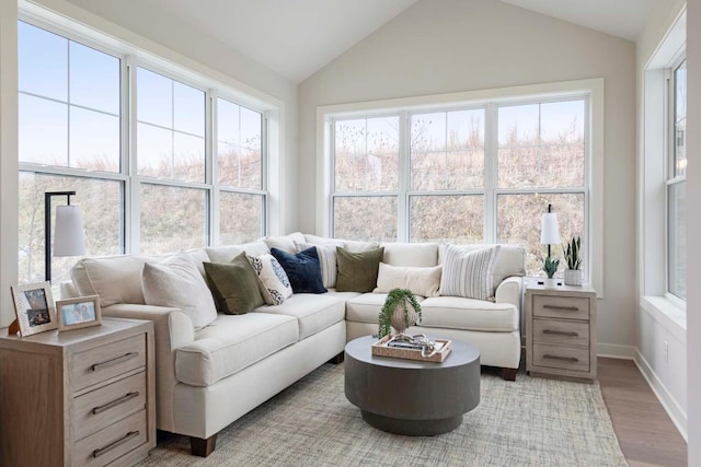 sunroom / solarium featuring vaulted ceiling and plenty of natural light