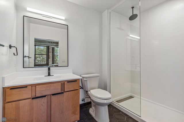 bathroom with toilet, vanity, tile patterned floors, and walk in shower