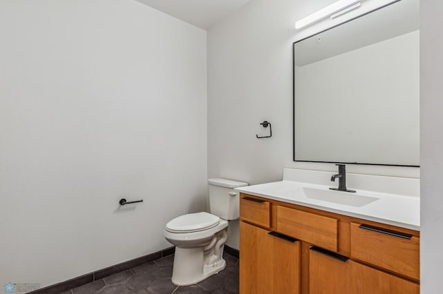 bathroom featuring tile patterned flooring, vanity, and toilet