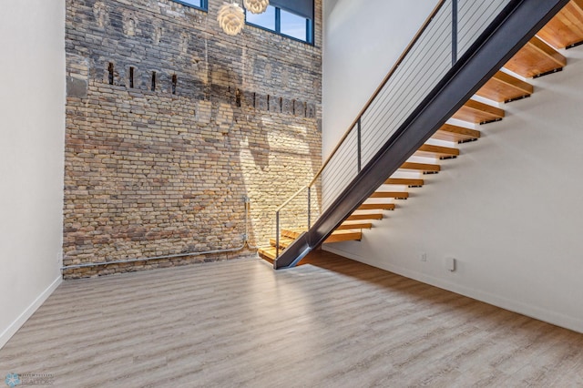 interior space with wood-type flooring and a high ceiling