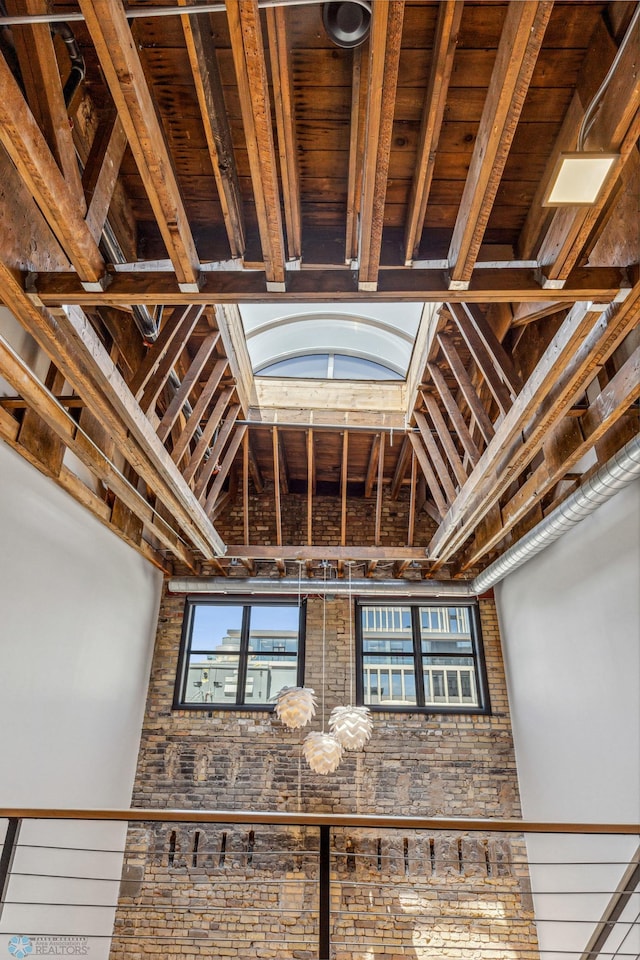 interior space featuring beam ceiling, a towering ceiling, and hardwood / wood-style flooring