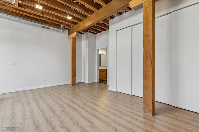 basement with light hardwood / wood-style flooring