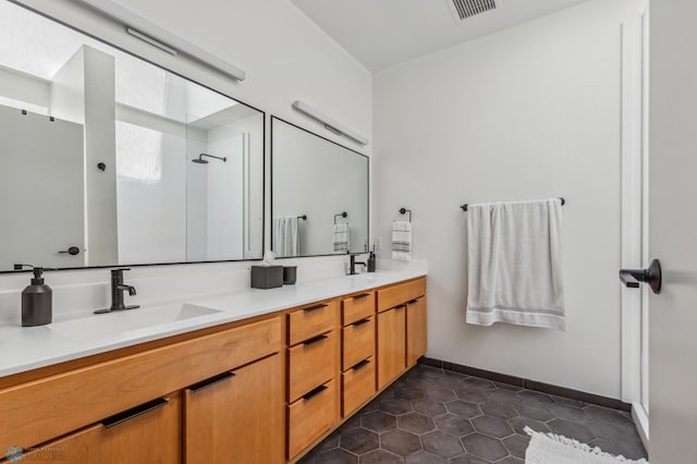 bathroom with tile patterned flooring and vanity