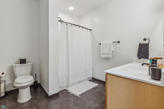 bathroom featuring curtained shower, tile patterned flooring, vanity, and toilet