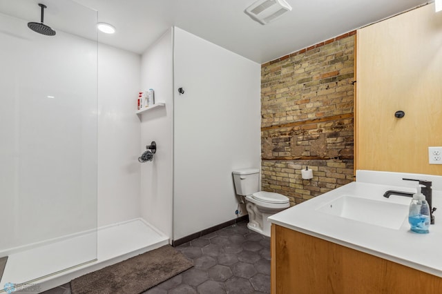 bathroom featuring a shower, tile patterned flooring, vanity, and toilet