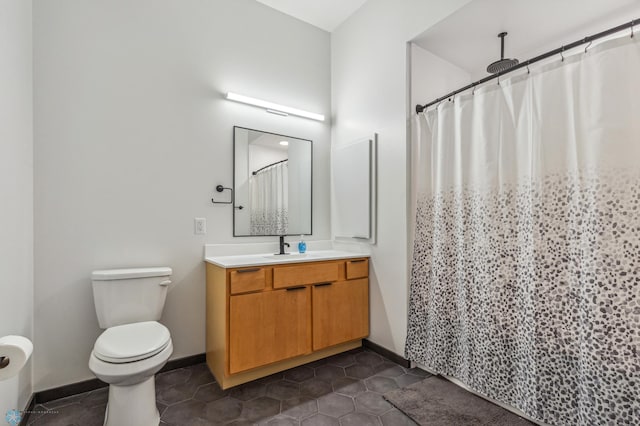 bathroom featuring tile patterned floors, vanity, curtained shower, and toilet