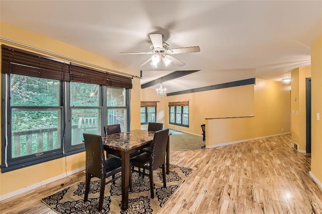 dining space featuring ceiling fan with notable chandelier and light wood-type flooring