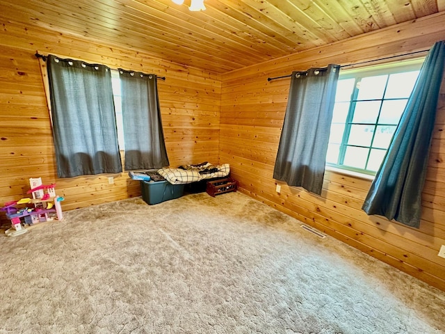 playroom with wood walls, carpet floors, and wood ceiling