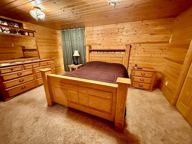bedroom with wood walls, wooden ceiling, and light colored carpet