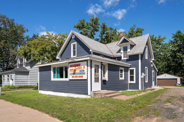 bungalow-style house featuring a garage, roof with shingles, a chimney, and a front yard