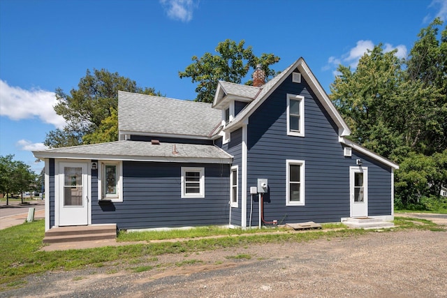 view of front of house with entry steps and a shingled roof