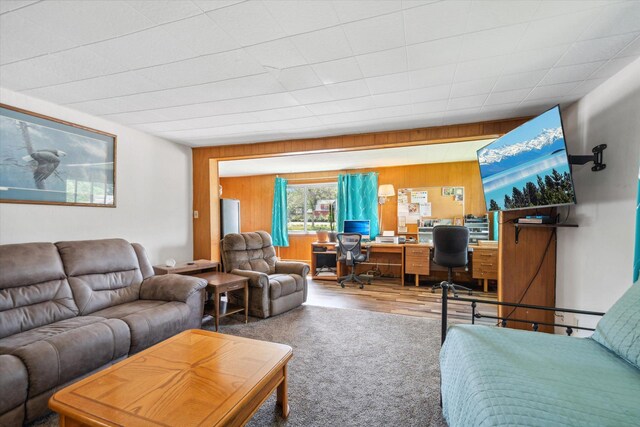 living room featuring wood finished floors and wooden walls