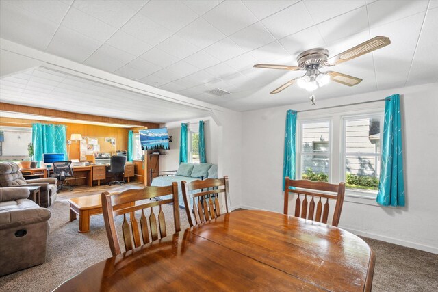 dining area with baseboards, a ceiling fan, and carpet flooring