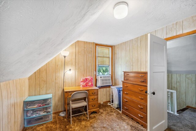 office with dark carpet, vaulted ceiling, wood walls, a textured ceiling, and cooling unit