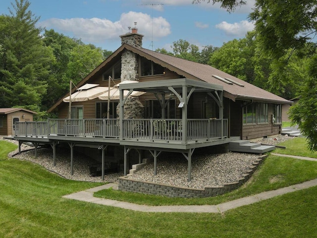 back of property with a yard and a deck