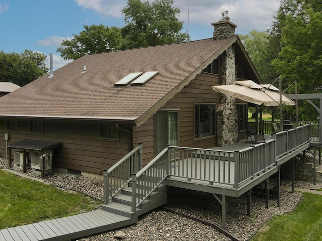 back of house featuring a wooden deck