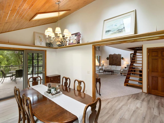 dining area with high vaulted ceiling, light wood-type flooring, wood ceiling, and an inviting chandelier