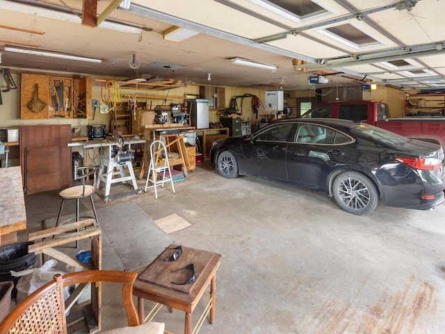 garage with a garage door opener and a workshop area