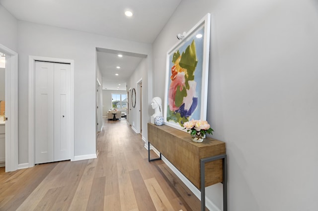 corridor with light hardwood / wood-style floors