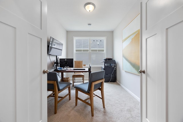 carpeted home office with baseboards