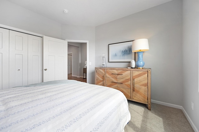 bedroom with light carpet and a closet