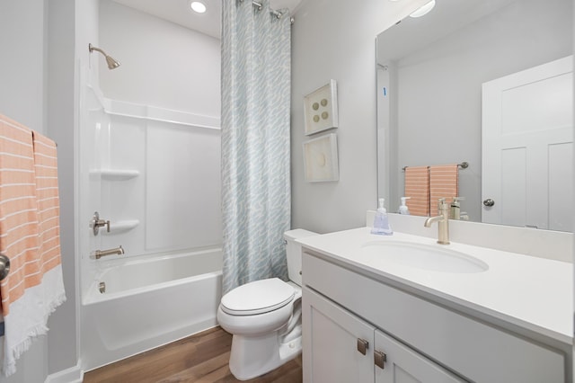 bathroom with shower / bathtub combination with curtain, toilet, vanity, and wood finished floors