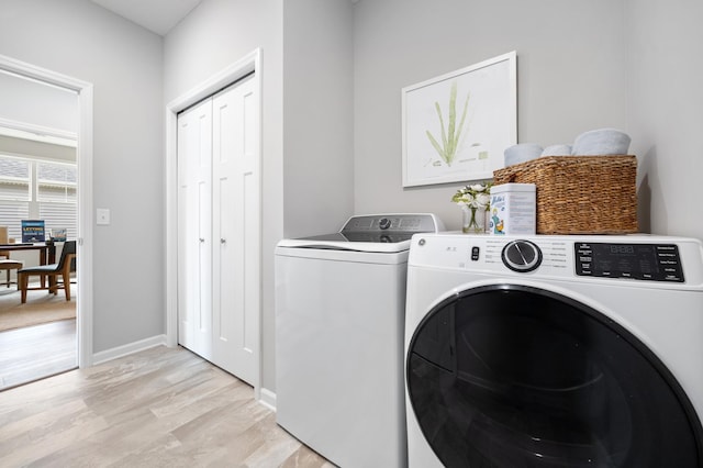 washroom with light hardwood / wood-style flooring and independent washer and dryer