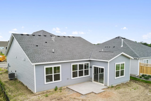 back of property with a patio, cooling unit, fence, and a shingled roof