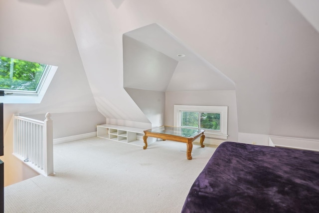 carpeted bedroom with lofted ceiling with skylight