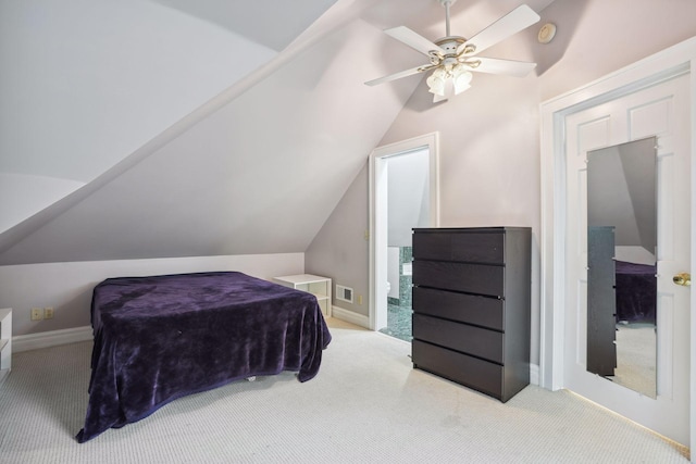 bedroom with lofted ceiling, light colored carpet, and ceiling fan