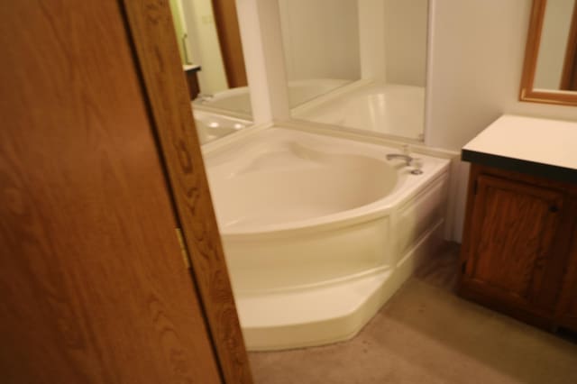 bathroom with vanity and a bathtub