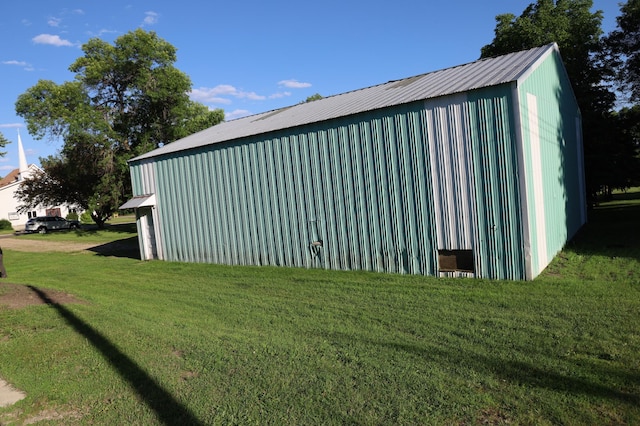 view of outbuilding featuring a yard