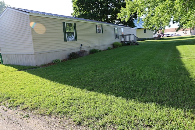 exterior space featuring a yard and central AC