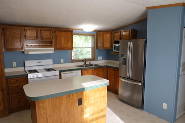 kitchen with a center island, sink, vaulted ceiling, a textured ceiling, and white appliances