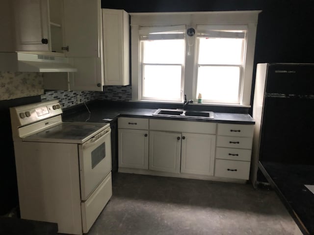 kitchen featuring white cabinets, black refrigerator, white electric range, sink, and tasteful backsplash