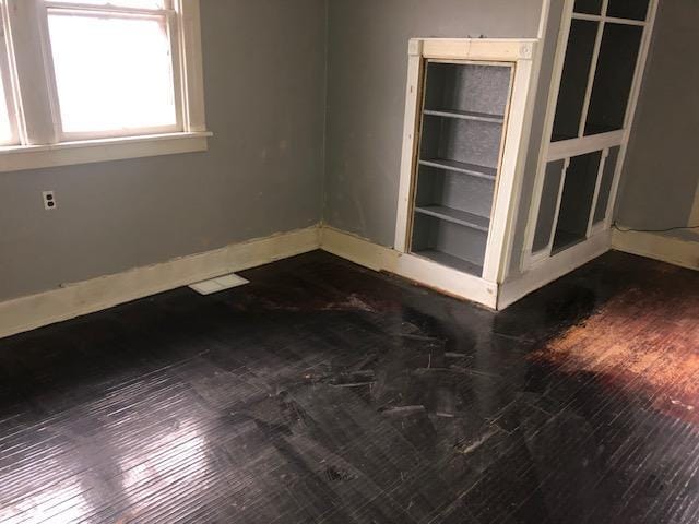 spare room with dark hardwood / wood-style floors