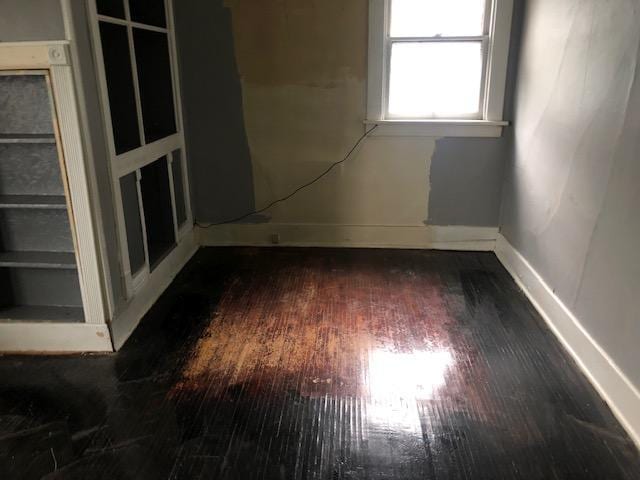 spare room with dark wood-type flooring