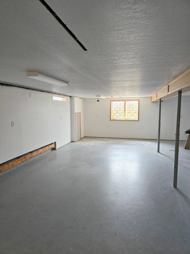 basement featuring a textured ceiling