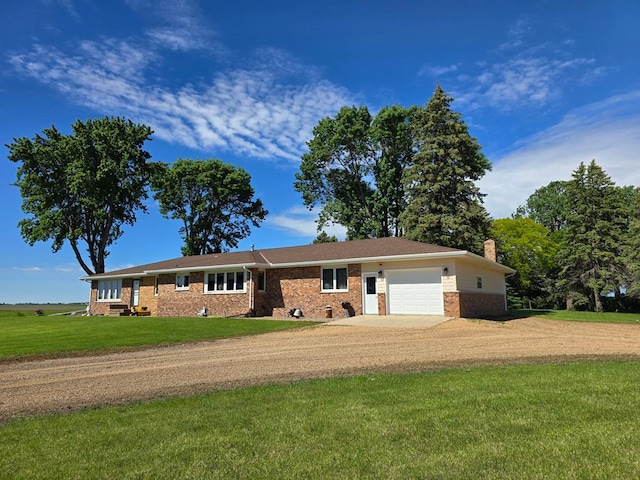 ranch-style home featuring a front lawn and a garage