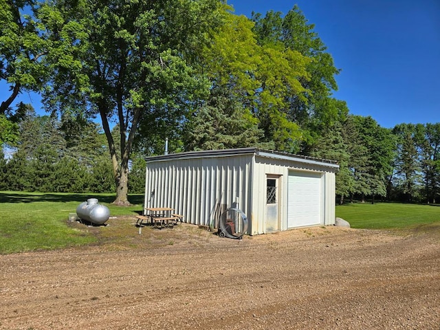 view of outdoor structure featuring a yard and a garage