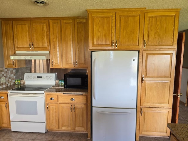 kitchen featuring white appliances, a textured ceiling, and tasteful backsplash